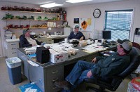 Kevin Stoy, right, with his father, Larry Stoy, and brother Ken Stoy, markets the grain his family grows on 13,000 acres. Photo by Dean Musser Jr./The Journal Gazette