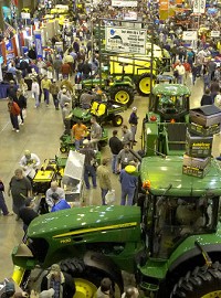 Crowds browse the rows of heavy-farm equipment at the Coliseum on Wednesday. Officials say demand for corn planters and seeding equipment is high at this year’s show. Photo by Clint Keller/The Journal Gazette