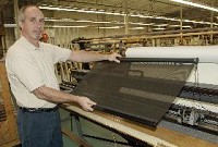 Ray Rump, Operations Manager fro United Shade, shows a shade thet protects from sun damage and blocks UV rays from people in RVs and now office buildings.Photo: Fred Flury / The Truth