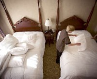 Guest Room Attendant Bethany Calhoun puts the finishing touches on a newly made bed at the French Lick Springs Resort and Casino. Photo by Rich Janzaruk