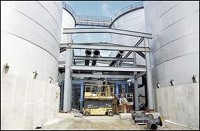 AT THE SITE - Work continues Monday at the Central Indiana Ethanol plant under construction west of Marion on Ind. 18. The rough winter has caused leaders to push back the likely opening date for the factory to June. OSCAR SALINAS / osalinas@marion.gannett.com