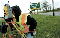 Just in case: Larry Davidson surveys property for the Indiana Department of Transportation on the northeast corner of the intersection of Ind. 28 and U.S. 31. Tipton County and Kokomo are still in the running for a possible new transmission plant.&nbsp; KT photo by Shawn Knapp