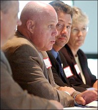 The Superintendents of the five area school districts participated in an education forum as part of the Leadership Academy of Madison County's forum on education and economics. Thomas Austin of Elwood Community Schools speaks during the forum as Ned Speicher, left of Frankton-Lapel Schools; James Willey of Alexandria Schools; and Mikella Lowe of Anderson Schools listen. John P. Cleary / The Herald Bulletin