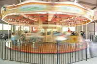 Visitors to the Fort Wayne Children’s Zoo, one of the region’s most recognized attractions, ride the merry-go-round. (Photo by Andy Barrand)