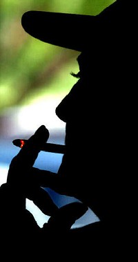 Jack &amp; Johnny’s employee Vicki Michael has a cigarette after her shift at the Wells Street tavern Thursday, the last day smoking is permitted in most of Fort Wayne’s public buildings. Laura J. Gardner/The Journal Gazette