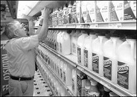 DEMAND HASN'T CHANGED - Store manager John Bone fills the milk case Friday at Lance's New Market, 1555 S. Western Ave. JEFF MOREHEAD / jmorehea@marion.gannett.com
&nbsp;