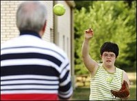 Abby Bahlmann, 20, practices softball skills Thursday night behind Hillcroft with her father, David Bahlmann. Abby is on the state waiting list for a waiver that helps people with developmental disabilities find jobs. Melissa Doss / The Star Press