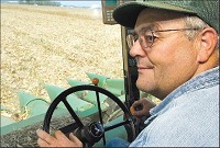 Dan Fiesbeck unloads corn from his combine to a semitrailer in a field near 700N and 200W in Taylorsville, Wednesday afternoon. Fiesbeck has been farming for 30 years and said this summer was dry, but it wasn’t even close to as bad as 1983. The Republic photo by Joel Philippsen