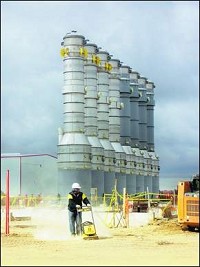 A construction worker tamps the ground near the evaporators at Cardinal Ethanol. Seth Slabaugh / The Star Press