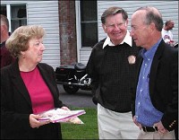 Jeanette Tudor offers Gov. Mitch Daniels a tray of cookies during his stop in Huntington on Wednesday. Becky Manley | The Journal Gazette