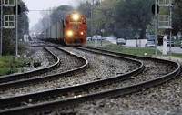 A train heads south Wednesday near the intersection of Main Street and Wood Street in Griffith. The number of trains on EJ&amp;E tracks in Griffith and several other local communities would triple under CN Railway's plan to purchase a smaller railroad. NATALIE BATTAGLIA | THE TIMES