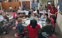 Paraprofessional Jennifer Wild helps a class of kindergarteners with lunch at Concord West Side Elementary. Truth photo by J. Tyler Klassen