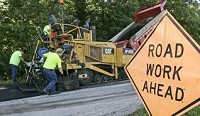 Rusty Lerch (left), Derrick Kelly (top) and Tony Misner lay asphalt Monday on Tippecanoe County Road 600 West, near West Point. The Tippecanoe County Road Department has gone to a four-day workweek to save money. By Michael Heinz/Journal &amp; Courier