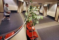 A man is seen in a mirror Friday as he walks through the empty terminal at the Purdue University Airport in West Lafayette. By Andrew Hancock/Journal &amp; Courier