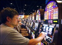 Hoosier Park Casino has generated close to $3 million in revenue in 2008 for Madison County governments. Stanley Kidd, of Muncie, plays his favorite slot machine at Hoosier Park Casino Thursday afternoon. Kidd says he comes to the casino 2 to 3 times a week to enjoy the slots. John P. Cleary / The Herald Bulletin