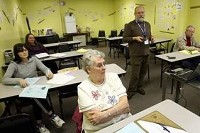 Lynda Turner answers a question as Phil Lyons instructs a class at WorkOne Friday on the do's and don'ts of interviewing. (Kurt Hostetler / The Star Press)