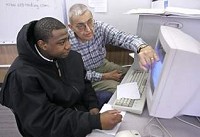 Volunteer Will Dillon (right) helps Mario Anderson with math problems Thursday at Lafayette Adult Resource Academy, 1100 Elizabeth St.&nbsp;By&nbsp;John Terhune/Journal &amp; Courier