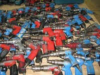 Screw guns, once used by the employees of AmeriCamp RV Co., have been collected, put into a large pile and are awaiting to be auctioned. Truth photo by Marilyn Odendahl