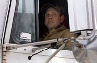 Dan Bartochowski, of Griffith, checks his mirrors as he practices backing up a semitrailer earlier this month in his final days of training at DriveCo in Gary. Bartochowski was laid off from his job in June 2008 and earned a grant through Workforce One to train at DriveCo for five days a week for a month.&nbsp; NATALIE BATTAGLIA | THE TIMES