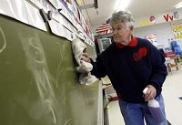 Perry Elementary custodian Geraldine Eley cleans a chalk board at the school Thursday afternoon. Eley offered to cut her hours in half because she didn’t want anyone else to lose their job. (Chris Bergin / The Star Press)