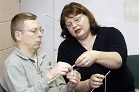Tom Smith works with teacher Sandra Martin as he learns to knit. A new group called YO! will teach people how to knit to help relieve the pressure of being unemployed. Jennifer Shephart/Truth photo