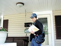 Greenwood postal carrier David Coombs delivers letters and packages along Meridian Street on Thursday morning. Throughout the state, mail volume is down more than 15 percent since October.STAFF PHOTO BY SARAH MICHALOS