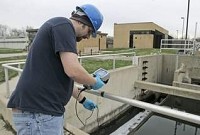 Jerome Mansfield, facility operator at the West Lafayette water treatment plant, does readings Thursday at the plant in West Lafayette. West Lafayette has five new employees on the payroll this year. By Michael Heinz/Journal &amp; Courier