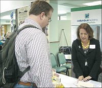 Cindy Frey, associate director of the Columbus Visitors Center, talks with Erik Deckers, who writes for visitIndiana.com, at a recent media fair. BRENDA SHOWALTER | THE REPUBLIC