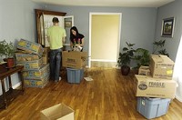 Ryley Siglar, right, and her boyfriend Stephen Kime pack boxes of china in Siglar`s living room Thursday, April 30, 2009. Ryley is moving to Texas with her mother, who has already moved. Ryley and her younger brother will join their mother next week. Truth Photo By Jennifer Shephard