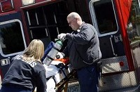 Medics Kiely Rednour and Mike Williams load up a stretcher with gear at Liberty Village Nursing Home on Monday. (Chris Bergin / THE&#8200;STAR&#8200;PRESS)