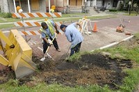 Elkhart City employees Steve Gates (left) and Shawn Haley work along State Street as part of a project to replace a catch basin. The community development department, which administers federal community development block grants and neighborhood stabilization program funds, is working to ensure the city will prosper once it comes out of the recession. J.Tyler Klassen/Truth Photo