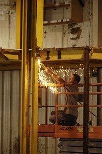 Steve Weaver uses a cutting torch Friday to disassemble hoists, lifts and catwalks at Lifetime RV in Wakarusa. Lifetime is preparing to begin operation in the facility previously occupied by former motorhome maker Travel Supreme. Truth photo by Jennifer Shephard