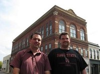 Brothers Brandon and Kyle Mundell (from left) pose outside their new acquisition, the Goddard building, in downtown Muncie. The two plan to relocate the Toys Forever model shop to the building.