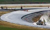 A worker with Hardcore Concrete Sawing &amp; Sealing cuts concrete for I-69 at State Road 68 Thursday morning. I-69 lanes can be seen in the background. DENNY SIMMONS / Courier &amp; Press