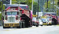 Two trucks transport sections of a new metal stamping press toward the Marion General Motors plant Wednesday on West Second Street. JEFF MOREHEAD / jmorehead@chronicle-tribune.com 