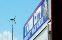 This 90-foot-tall wind turbine with 8-foot-long blades generates 1,000 watts of power for Union City Community High School. The project could be a model for how ECI schools could spend the $12 million they have been awarded to pursue wind and geothermal energy projects. (The Star Press file photo)