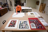 Gregg Hertzlieb, director of the Valparaiso University&nbsp;Brauer&nbsp;Museum&nbsp;of&nbsp;Art, frames prints by Japanese artist Sadao Watanabe for an exhibit. Curators in the area have been cutting back and doing more work themselves as their budgets have shrunk. JON L. HENDRICKS | THE TIMES 