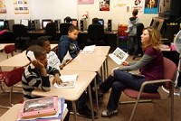 Lisa Brady reads Wednesday with 5th grade students in her title I class at Merrillville Intermediate School. This is only the 2nd year at MIS for title I, and last year there was only one class with both grade 5 and 6 combined, but thanks to federal stimulus dollars the school district was able to add another teacher and aide. JOHN LUKE | THE TIMES MERRILLVILLE