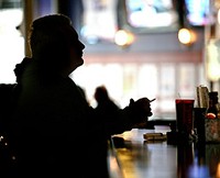Local patrons like Kenneth Fegett still enjoy a smoke at the Front Page and other area bars. (IBJ Photo/ Perry Reichanadter)