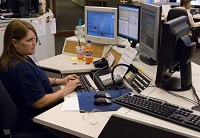 Call-taker Kelly Nurrenbern receives a 911 call Tuesday during her shift at Central Dispatch. DENNY SIMMONS / Courier &amp; Press