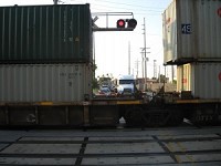 Trucks and cars line up on the other side of a stopped train just northeast of the intersection of Dickey Road and Michigan Avenue on Friday morning. The number of vehicles per day using Dickey Road has soared from 3,610 before the Cline Avenue bridge closure to 17,224 recently. 