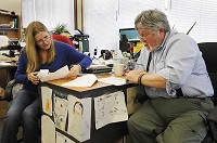 Trustee Dan Combs and his wife, Pat Combs, listen to case managers Tuesday at their daily meeting at the Perry Township offices on South Walnut Street in Bloomington. The case managers help evaluate which requests for aid should be granted. Chris Howell | Herald-Times