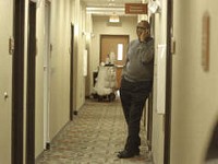 Rep. Charlie Brown, of Gary, makes a call in the first floor hallway of an Urbana, Illinois hotel Wednesday Feb. 23, 2011.Brown and more than 20 other members of the Indiana House Democratic caucus met behind closed doors for most of the morning. | Andy Lavalley~Sun-Times Media
