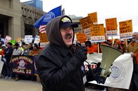 Kurt Mullins of Michigan City mans a bullhorn for USW District 7 and helps rally the crowd during a labor rally outside the Indiana Statehouse. | Scott M. Bort-Post-Tribune
