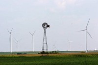 An old windmill stands with the new power-generating windmills in Benton County. | Scott M. Bort ~ Post-Tribune
