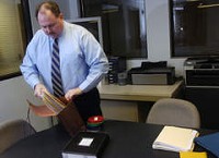 Dyer Police sgt. Don Foley packs up the case file on the murder of Beverly Thompson. Foley is the leads manager for the Northwest Indiana Major Crimes Task Force. | Jeffrey D. Nicholls~Sun-Times Media