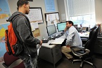 Spencer Blade, left, of Terre Haute, checks in with Brad Bates, a student support services academic counselor, after attending his first class of the day at the University of Southern Indiana recently. Blade is pursuing a degree in business administration and graduated from Ivy Tech before transferring to USI. Blade has benefited from the academic and financial advice offered by student support services at USI.JASON CLARK / Evansville Courier &amp; Press