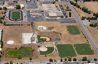 Kept alive: The various athletic fields at Terre Haute South High School stand out in stark contrast to the parched earth surrounding them. Staff photo by Joseph C. Garza