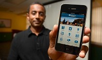 New app: Santhana Naidu, web services director in Indiana State's Office of Communications, shows off the university's new mobile phone app, ISU Mobile, after a press conference in the Hulman Memorial Student Union Wednesday. Staff photo by Joseph C. Garza