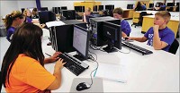 Put to good use: Students at Eastern Hancock Middle School work in a computer lab outfitted with desktop machines donated by the White family. Staff photo by Tom Russo